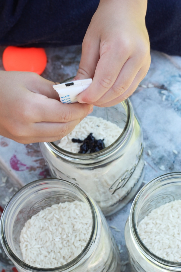 Adding food dye to rice for sensory bin