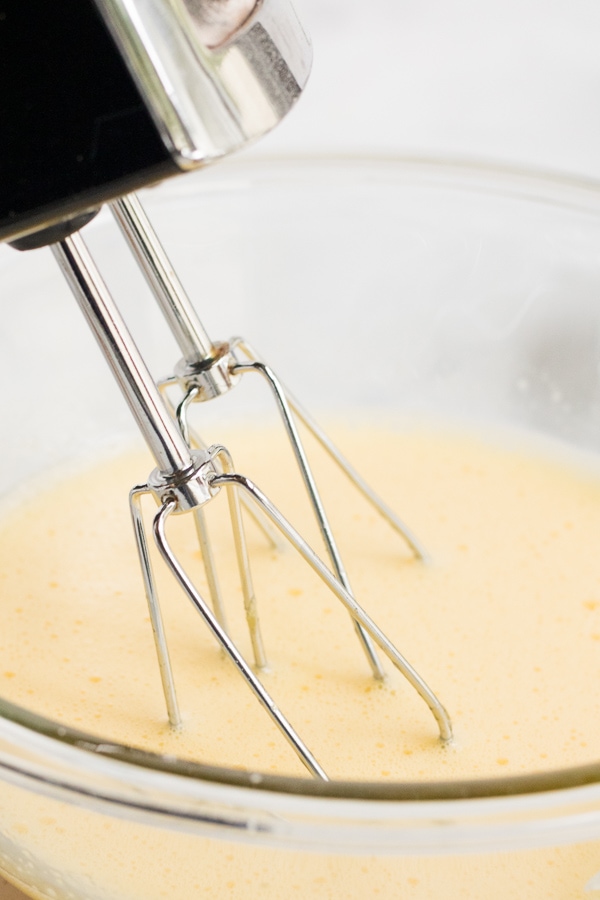 hand mixer beating eggnog ingredients