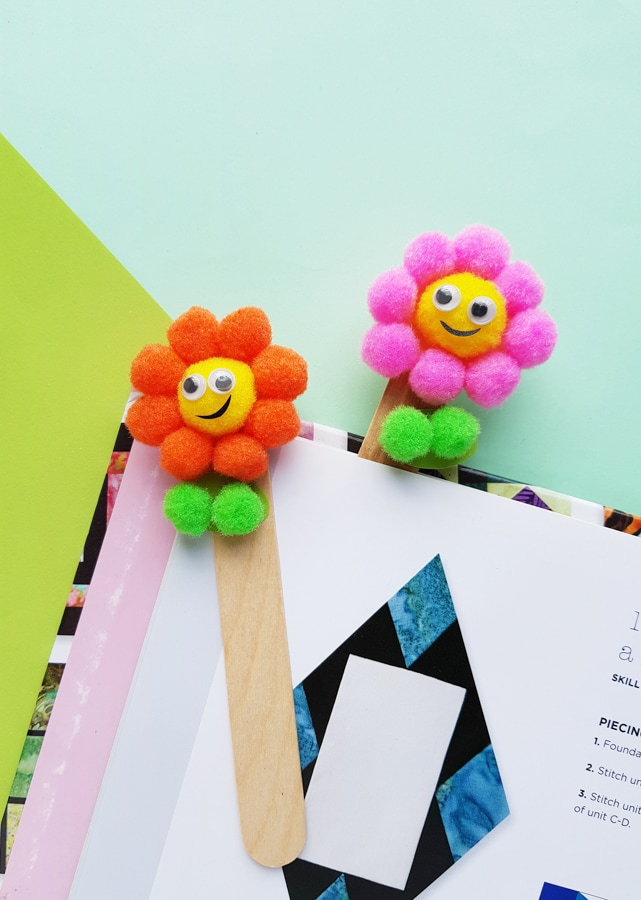making flower bookmarks with pom poms and popsicle sticks