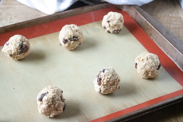 making soft oatmeal raisin cookies, dough balls on a baking mat