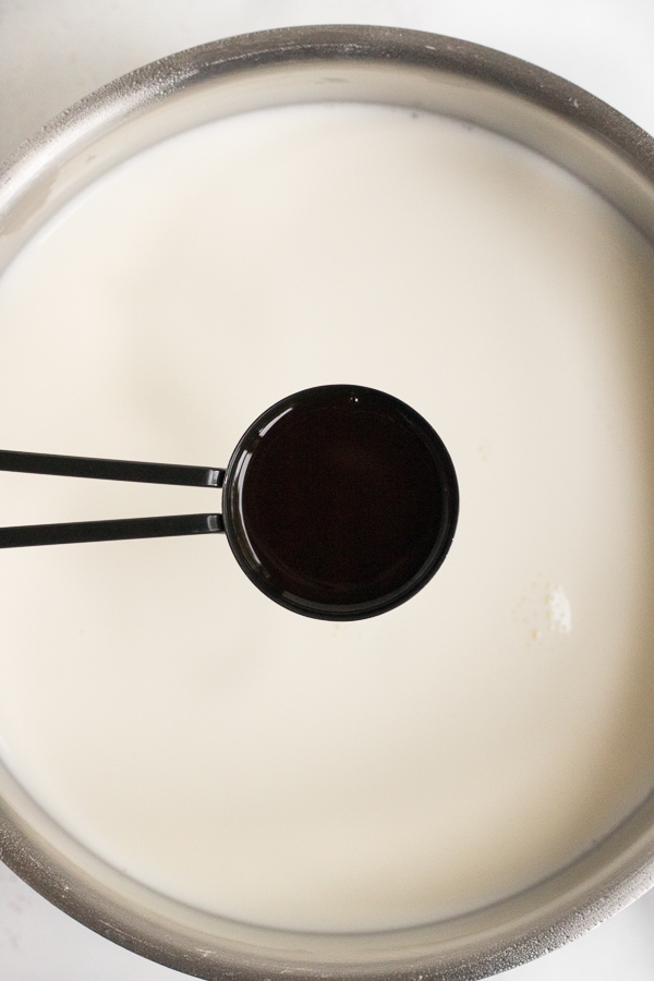 spoonful of vanilla to be poured into milk to start eggnog