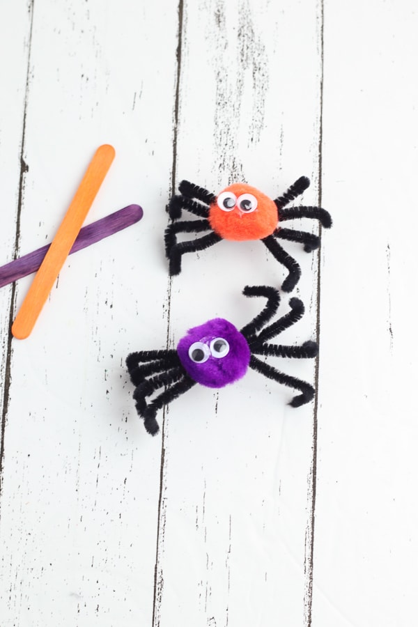 adding googly eyes to spider puppets